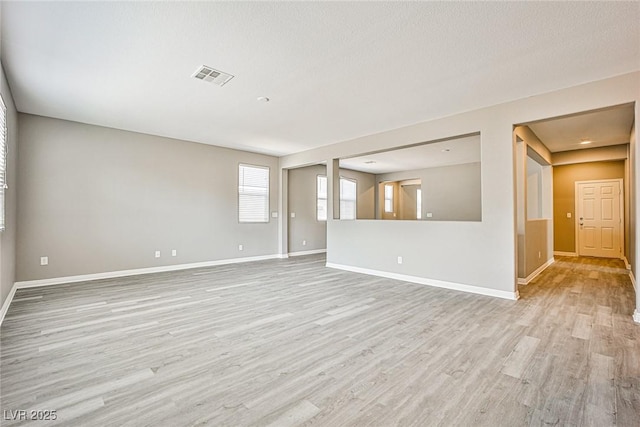 9271 Martel Ave, Las Vegas, NV 89148 - unfurnished living room featuring light wood-style floors and baseboards