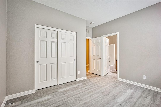 9271 Martel Ave, Las Vegas, NV 89148 - unfurnished bedroom with wood finished floors, baseboards, a closet, and ensuite bathroom