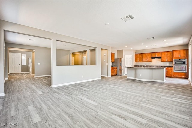 9271 Martel Ave, Las Vegas, NV 89148 - unfurnished living room with light wood-style flooring, baseboards, recessed lighting, and a sink