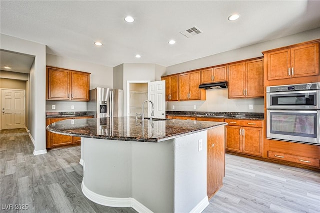 9271 Martel Ave, Las Vegas, NV 89148 - kitchen featuring stainless steel appliances, brown cabinetry, and recessed lighting