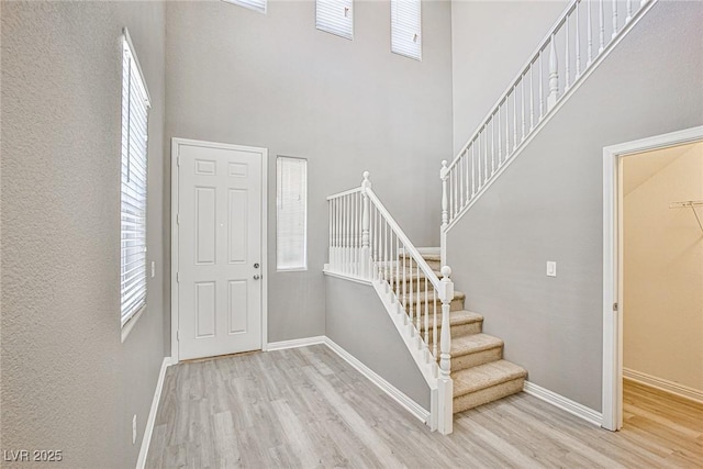 9271 Martel Ave, Las Vegas, NV 89148 - staircase with wood finished floors, a towering ceiling, and baseboards