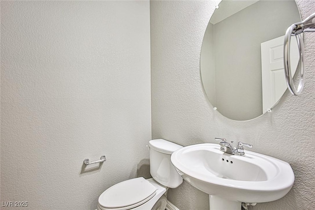 9271 Martel Ave, Las Vegas, NV 89148 - half bath with toilet, a textured wall, and a sink