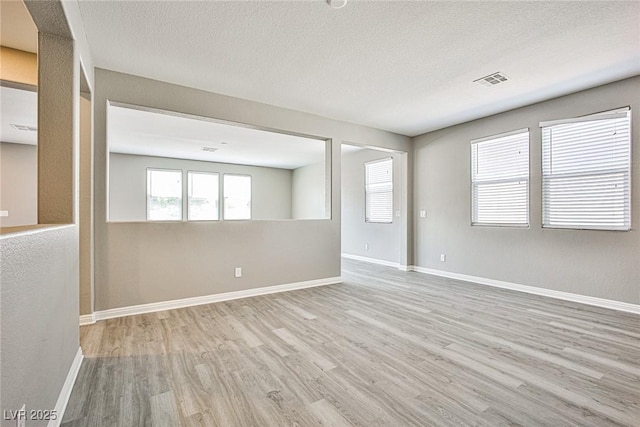 9271 Martel Ave, Las Vegas, NV 89148 - spare room with wood finished floors, baseboards, and a textured ceiling