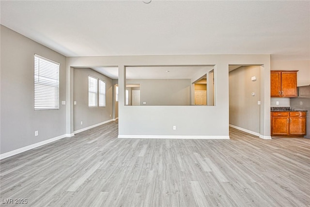 9271 Martel Ave, Las Vegas, NV 89148 - unfurnished living room with light wood finished floors and baseboards