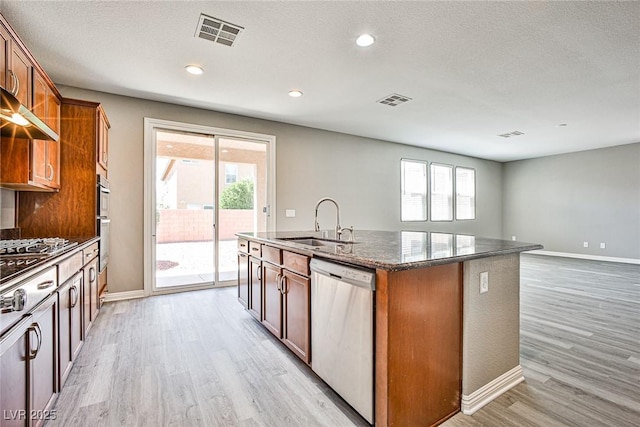 9271 Martel Ave, Las Vegas, NV 89148 - kitchen featuring stainless steel dishwasher, a sink, light wood-type flooring, healthy amount of natural light, and a textured ceiling