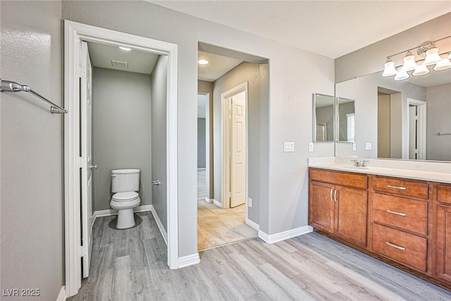 9271 Martel Ave, Las Vegas, NV 89148 - full bath with wood finished floors, vanity, toilet, and baseboards