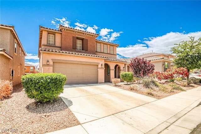9271 Martel Ave, Las Vegas, NV 89148 - mediterranean / spanish-style home with driveway, stucco siding, a tiled roof, and an attached garage