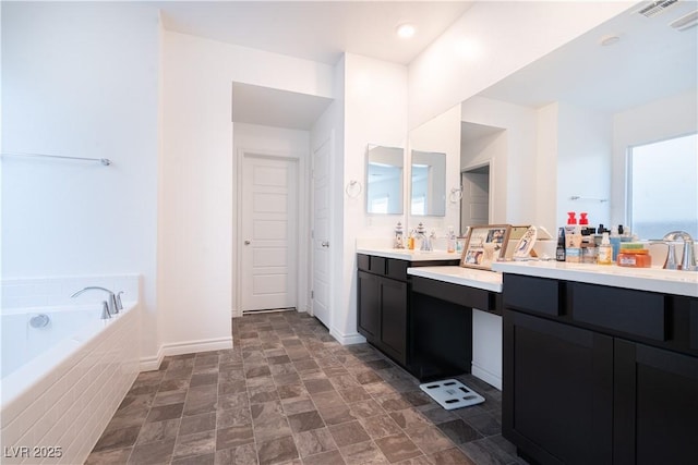 4376 Latitude Valley Ct, North Las Vegas, NV 89084 - full bathroom featuring vanity, a garden tub, baseboards, and stone finish flooring
