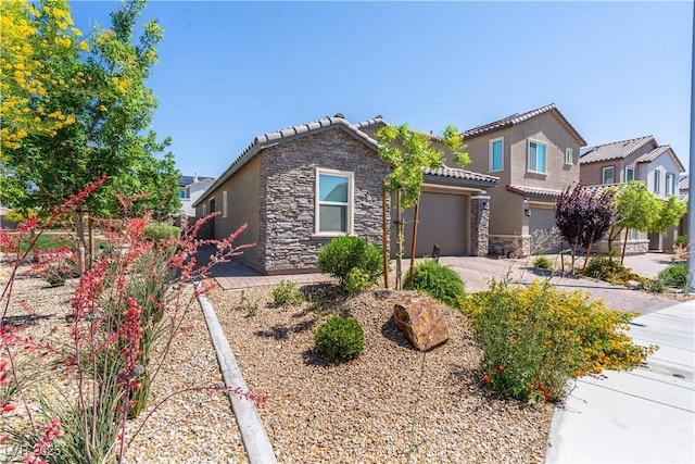 4376 Latitude Valley Ct, North Las Vegas, NV 89084 - view of front facade with stone siding, a tile roof, stucco siding, a garage, and driveway