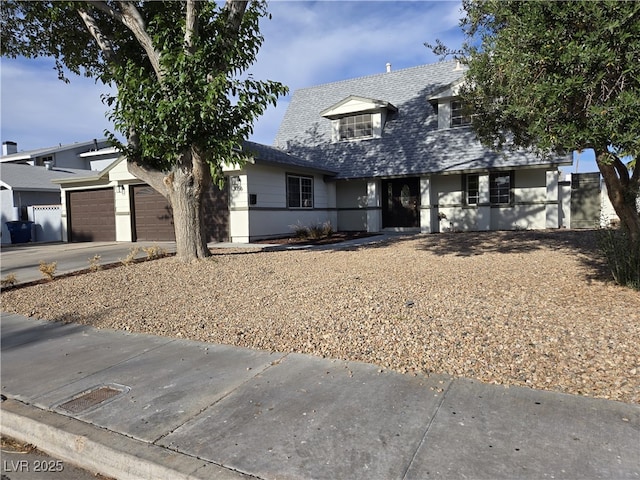 3056 Garnet Ct, Las Vegas, NV 89121 - cape cod house with an attached garage, driveway, and roof with shingles