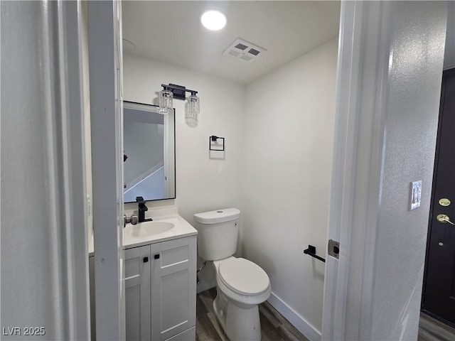 3056 Garnet Ct, Las Vegas, NV 89121 - bathroom featuring vanity, toilet, baseboards, and wood finished floors