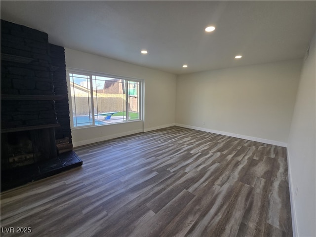 3056 Garnet Ct, Las Vegas, NV 89121 - unfurnished living room featuring wood finished floors, recessed lighting, baseboards, and a fireplace