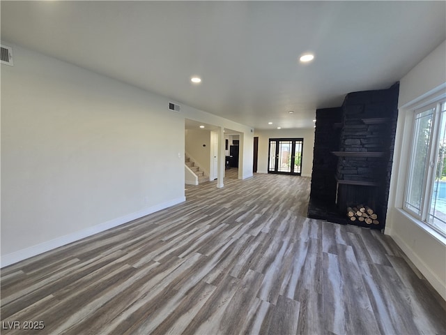3056 Garnet Ct, Las Vegas, NV 89121 - unfurnished living room with stairs, baseboards, wood finished floors, plenty of natural light, and recessed lighting