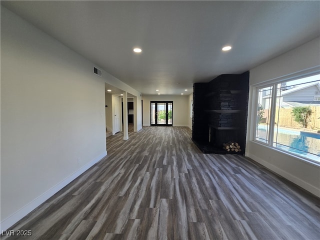 3056 Garnet Ct, Las Vegas, NV 89121 - unfurnished living room with a large fireplace, baseboards, dark wood finished floors, and recessed lighting