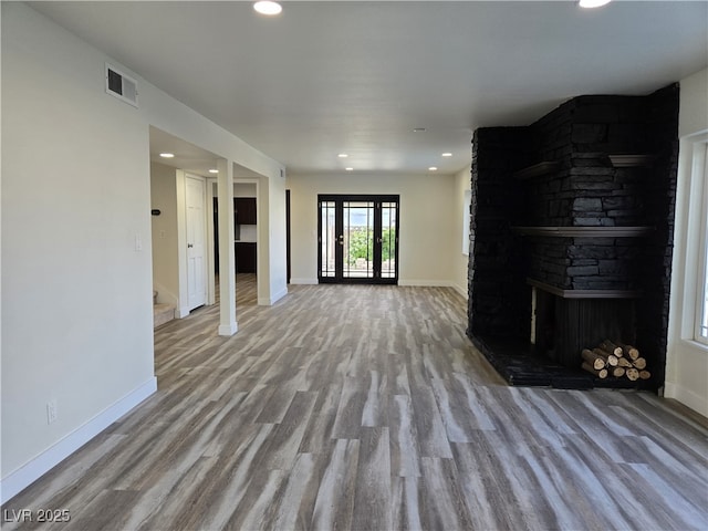 3056 Garnet Ct, Las Vegas, NV 89121 - unfurnished living room featuring baseboards, wood finished floors, recessed lighting, a fireplace, and stairway