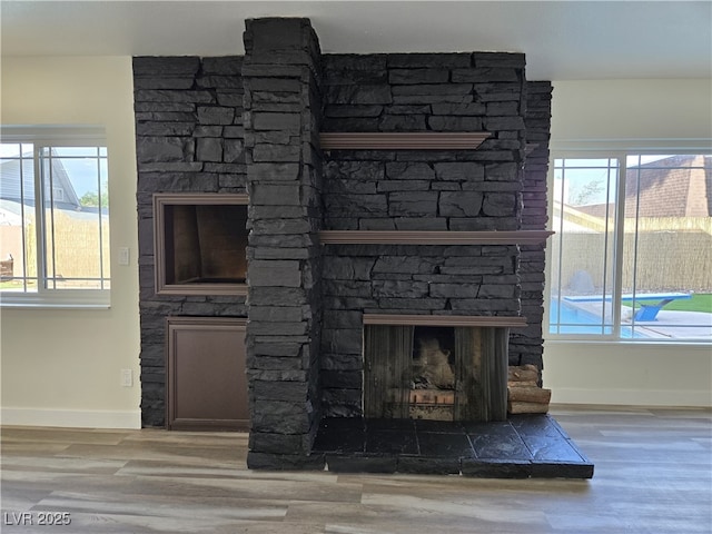 3056 Garnet Ct, Las Vegas, NV 89121 - detailed view of a fireplace, wood finished floors, and baseboards