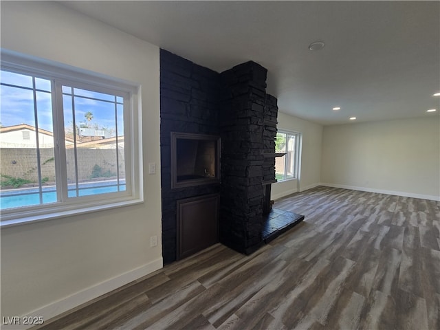 3056 Garnet Ct, Las Vegas, NV 89121 - unfurnished living room with a fireplace, baseboards, wood finished floors, and recessed lighting
