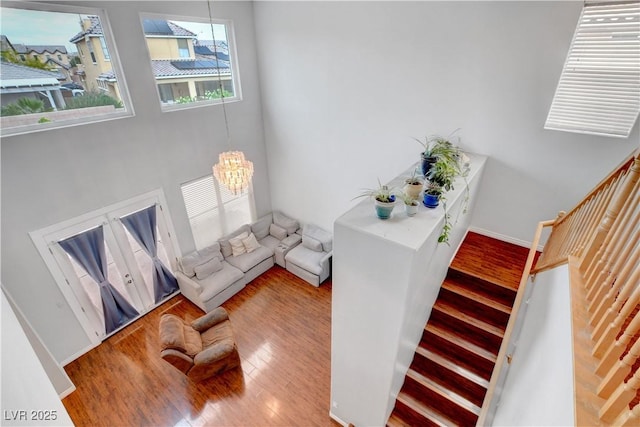5642 Breckenridge St, North Las Vegas, NV 89081 - living area with wood finished floors, stairs, a chandelier, and baseboards