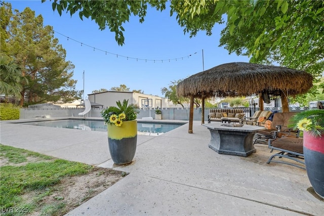 7545 Constantinople Ave, Las Vegas, NV 89129 - view of pool with a water slide, a gazebo, a patio, and an outdoor living space with a fire pit