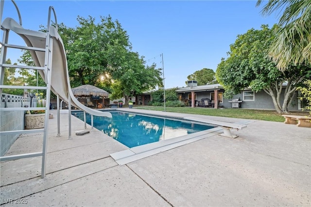 7545 Constantinople Ave, Las Vegas, NV 89129 - view of pool featuring a water slide, a patio area, and a diving board