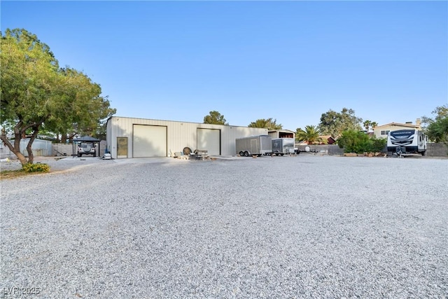 7545 Constantinople Ave, Las Vegas, NV 89129 - view of front facade with a detached garage, driveway, and an outbuilding