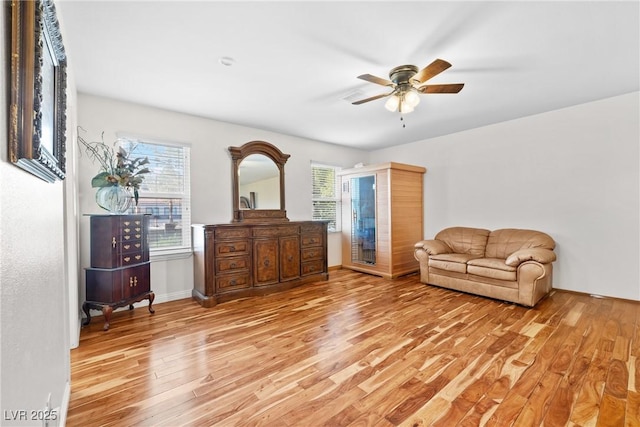 7545 Constantinople Ave, Las Vegas, NV 89129 - living area with light wood finished floors, plenty of natural light, ceiling fan, and baseboards