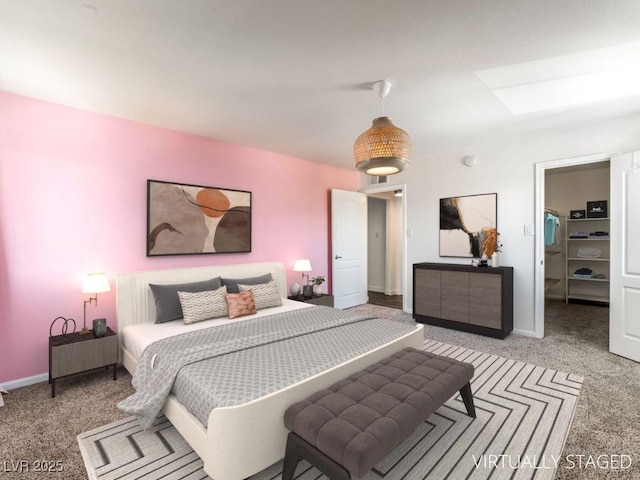 753 Oakmont Ave Unit 802, Las Vegas, NV 89109 - bedroom with carpet floors, a walk in closet, baseboards, and a skylight
