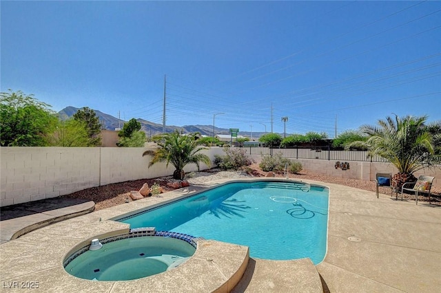 3112 Haddon Dr, Las Vegas, NV 89134 - view of swimming pool with a pool with connected hot tub, a fenced backyard, a mountain view, and a patio area