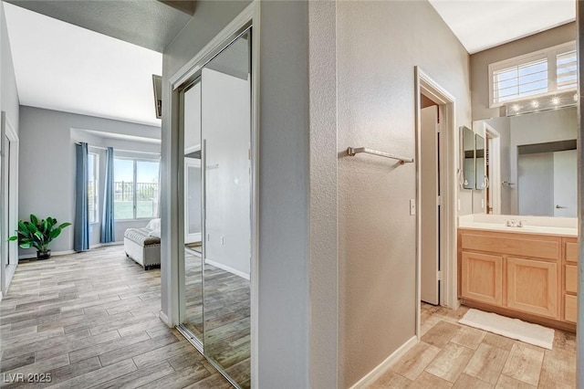 3112 Haddon Dr, Las Vegas, NV 89134 - bathroom with wood finished floors, vanity, and a textured wall