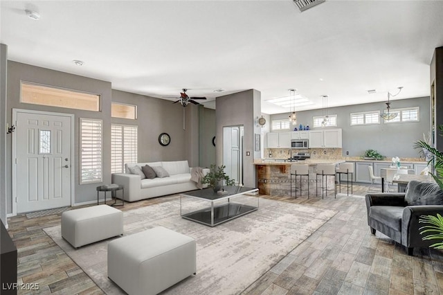 3112 Haddon Dr, Las Vegas, NV 89134 - living area featuring light wood finished floors, a ceiling fan, and healthy amount of natural light