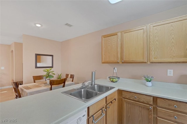 6217 Lapilli Ave, Las Vegas, NV 89139 - kitchen featuring light brown cabinetry, light countertops, a sink, baseboards, and light wood-style floors