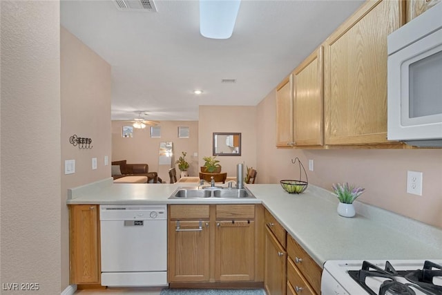 6217 Lapilli Ave, Las Vegas, NV 89139 - kitchen with white appliances, light countertops, a sink, ceiling fan, and a peninsula