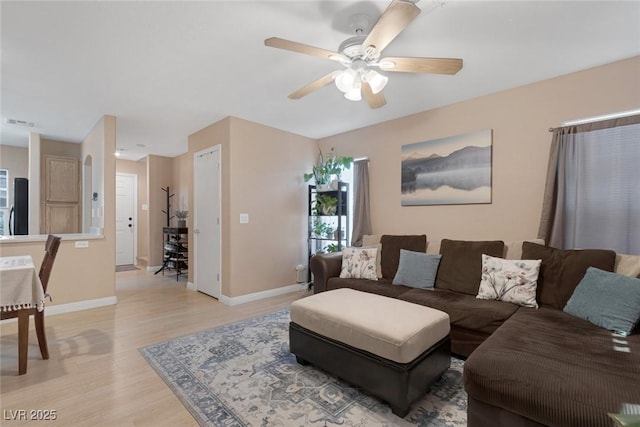 6217 Lapilli Ave, Las Vegas, NV 89139 - living area with light wood-style floors, a ceiling fan, and baseboards