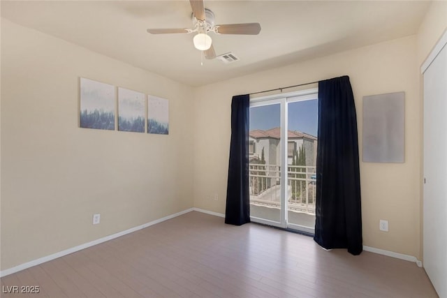 6217 Lapilli Ave, Las Vegas, NV 89139 - spare room with wood finished floors, ceiling fan, and baseboards