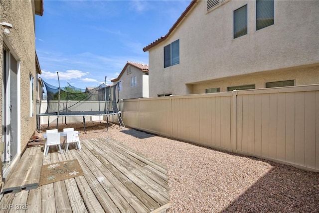 9039 Alex Creek Ave, Las Vegas, NV 89149 - wooden deck with a trampoline and a fenced backyard