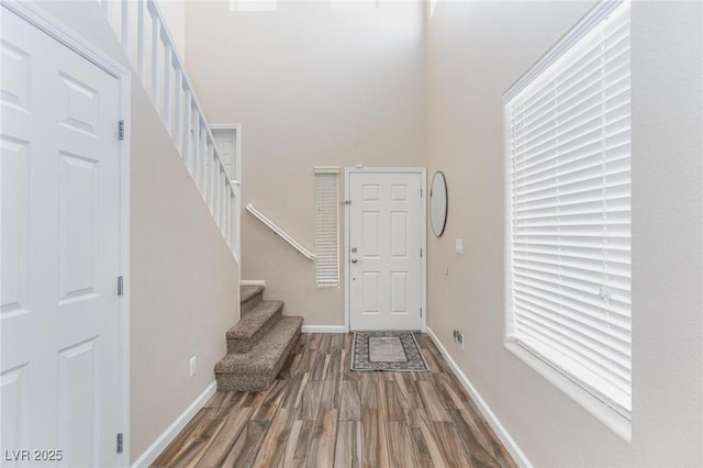9039 Alex Creek Ave, Las Vegas, NV 89149 - entrance foyer with wood finished floors, stairs, baseboards, and a high ceiling
