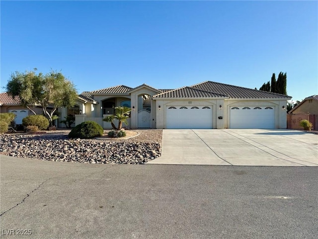 5451 Fernwood Ct, Pahrump, NV 89061 - view of front facade with driveway, an attached garage, stucco siding, and a tile roof