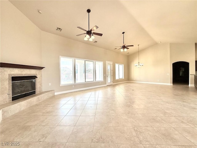 5451 Fernwood Ct, Pahrump, NV 89061 - unfurnished living room featuring a premium fireplace, ceiling fan, light tile patterned floors, high vaulted ceiling, and baseboards