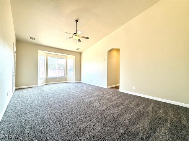 5451 Fernwood Ct, Pahrump, NV 89061 - unfurnished room with ceiling fan, carpet floors, arched walkways, baseboards, and high vaulted ceiling