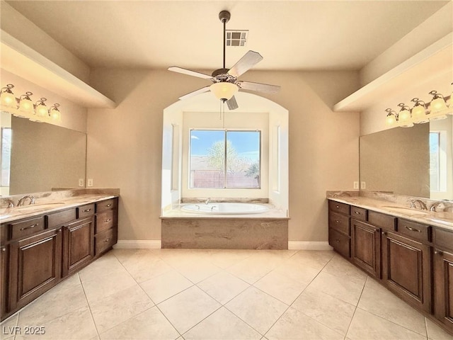 5451 Fernwood Ct, Pahrump, NV 89061 - full bath with a ceiling fan, healthy amount of natural light, a garden tub, and two vanities