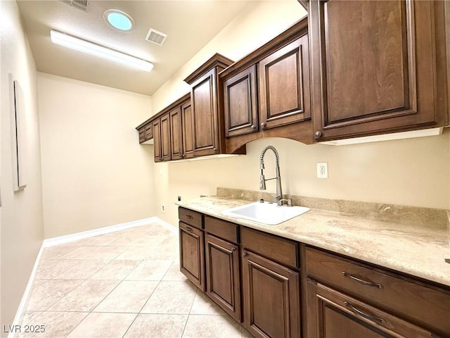 5451 Fernwood Ct, Pahrump, NV 89061 - laundry room featuring cabinet space, washer hookup, light tile patterned flooring, and baseboards