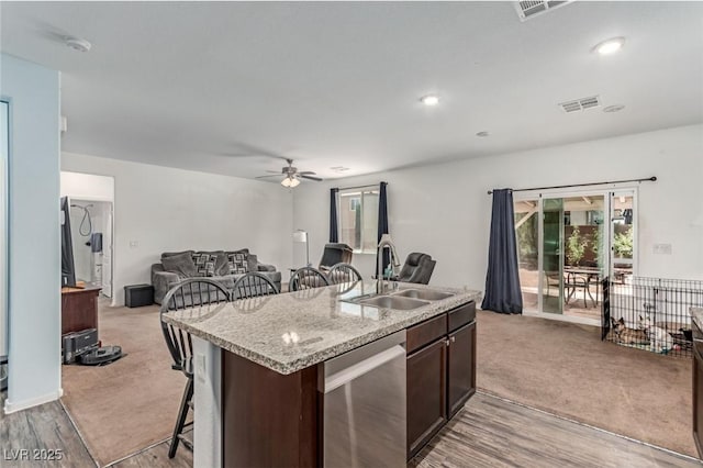 3821 E Summit Ave, Pahrump, NV 89061 - kitchen featuring a sink, dishwasher, a kitchen breakfast bar, a ceiling fan, and dark brown cabinets