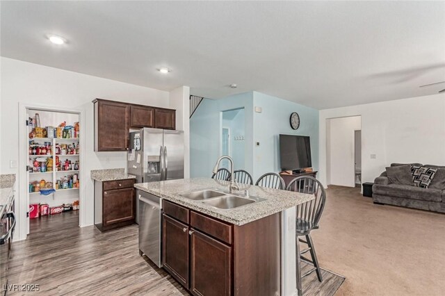 3821 E Summit Ave, Pahrump, NV 89061 - kitchen with appliances with stainless steel finishes, a sink, a kitchen bar, open floor plan, and a kitchen island with sink