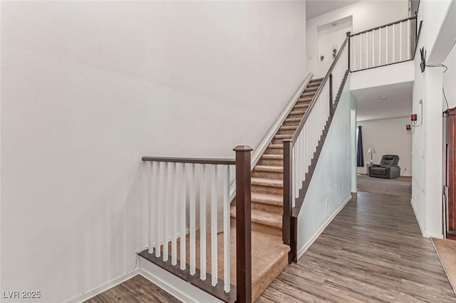 3821 E Summit Ave, Pahrump, NV 89061 - staircase with wood finished floors, baseboards, and a towering ceiling
