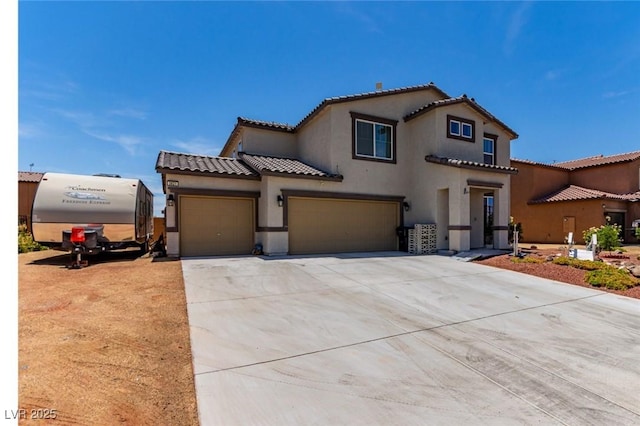 3821 E Summit Ave, Pahrump, NV 89061 - mediterranean / spanish-style house featuring stucco siding, a tile roof, concrete driveway, and a garage