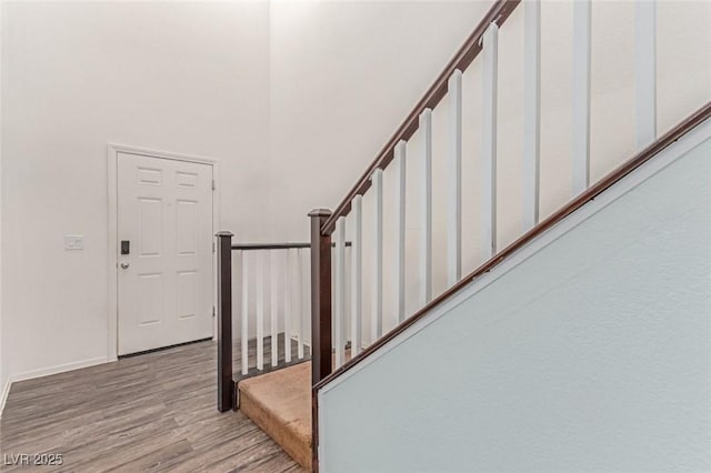 3821 E Summit Ave, Pahrump, NV 89061 - stairway featuring wood finished floors, baseboards, and a towering ceiling