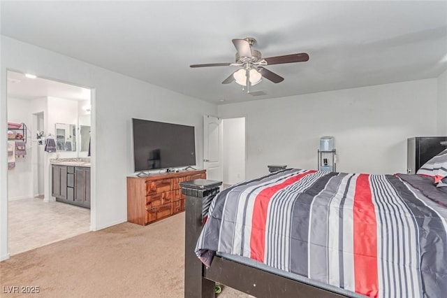 3821 E Summit Ave, Pahrump, NV 89061 - bedroom with light carpet, a ceiling fan, and connected bathroom