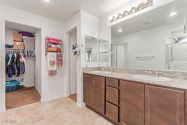 3821 E Summit Ave, Pahrump, NV 89061 - bathroom featuring double vanity, a spacious closet, baseboards, and tile patterned floors