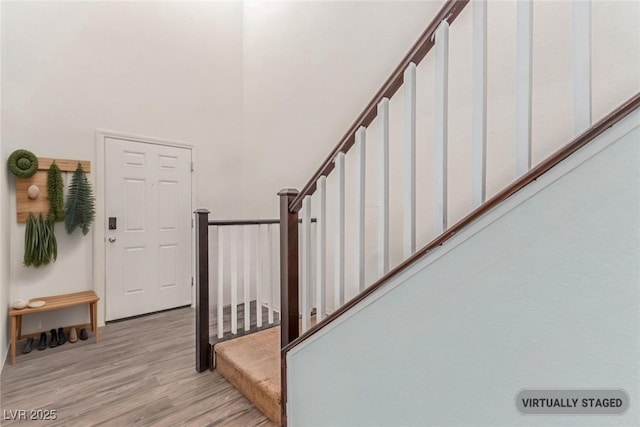 3821 E Summit Ave, Pahrump, NV 89061 - stairway featuring wood finished floors, a towering ceiling, and baseboards