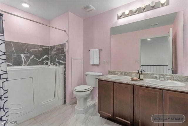 3821 E Summit Ave, Pahrump, NV 89061 - bathroom with double vanity, toilet, washer / clothes dryer, marble finish flooring, and shower / tub combo